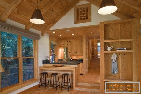 Інтер'єр дерев'яного будинку з бруса всередині - фото кухні вітальні