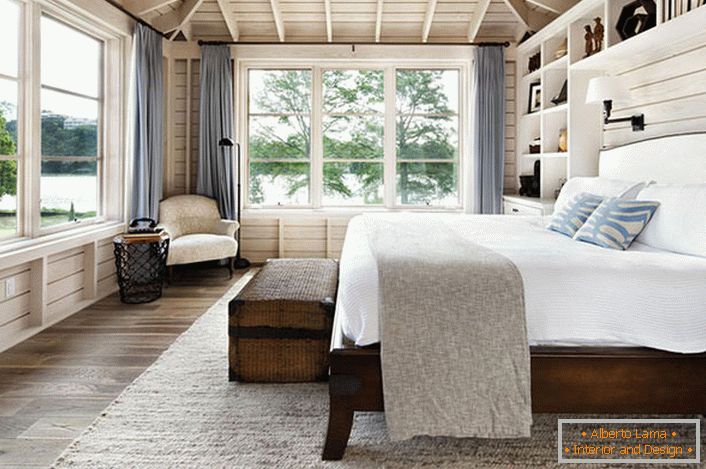 Спальня в скандинавському стилі з великим двоспальним ліжком з дерева в будинку французького бізнесмена.