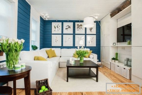 Білий диван в інтер'єрі з синіми шпалерами і дерев'яною підлогою