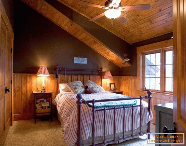 Спальня для гостей на мансардному поверсі в стилі шале простора і не заставлена ​​зайвими декоративними елементами.